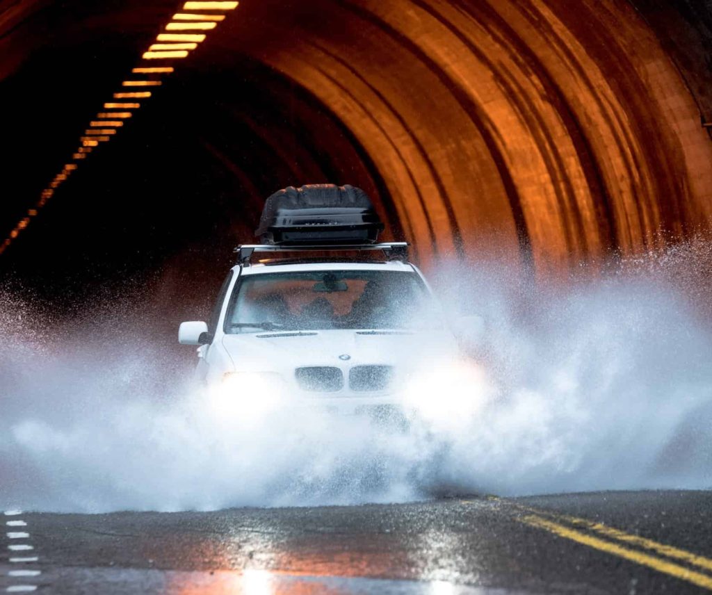 BMW DRIVING ON WET ROAD