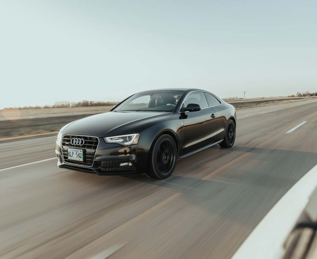 AUDI DRIVING DOWN THE STREET
