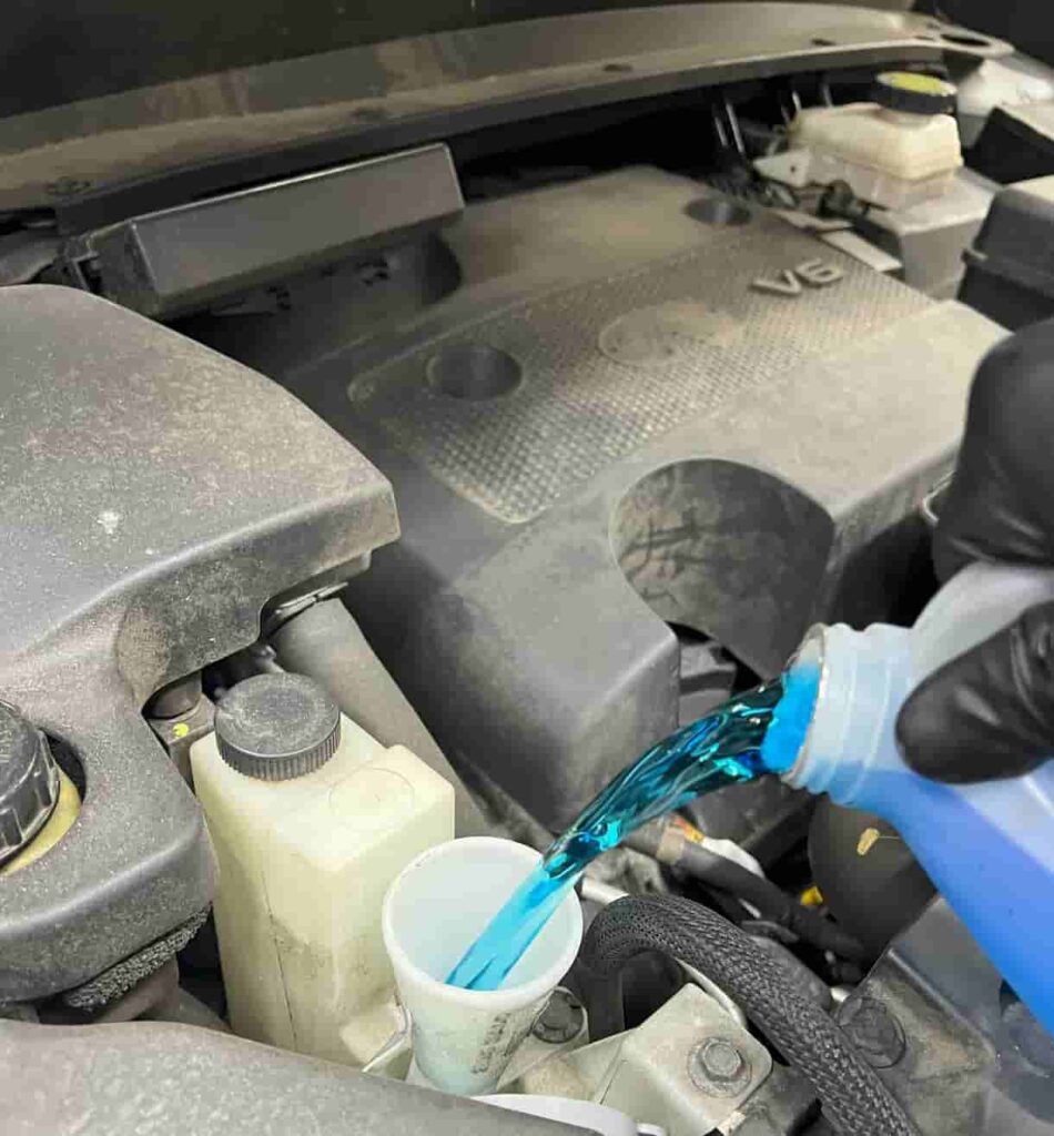 POURING WASHER FLUID INTO RESERVOIR